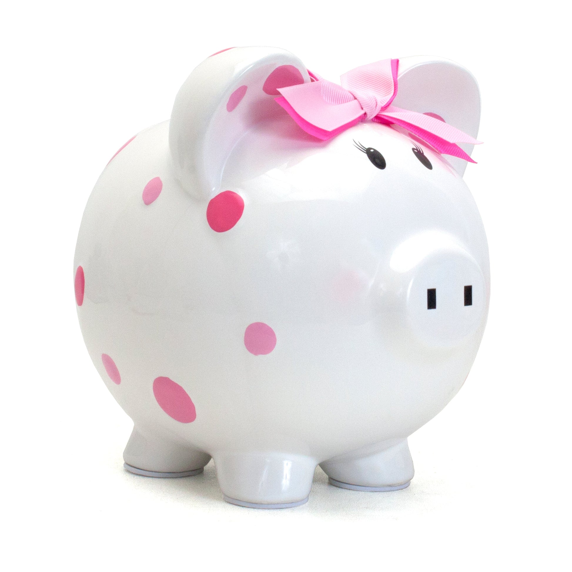 White ceramic piggy bank with pink polka dots and pink bow on ear, side angle view