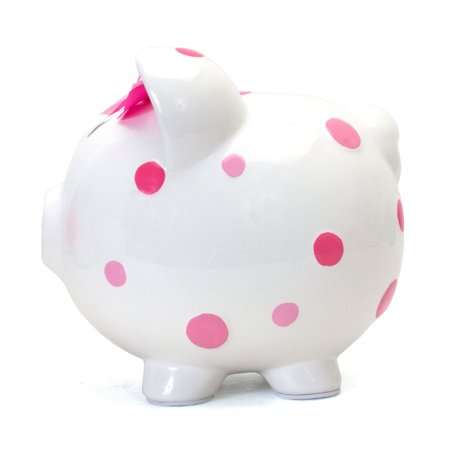 Rear view of white piggy bank with pink polka dots and pink bow, showing base and tail
