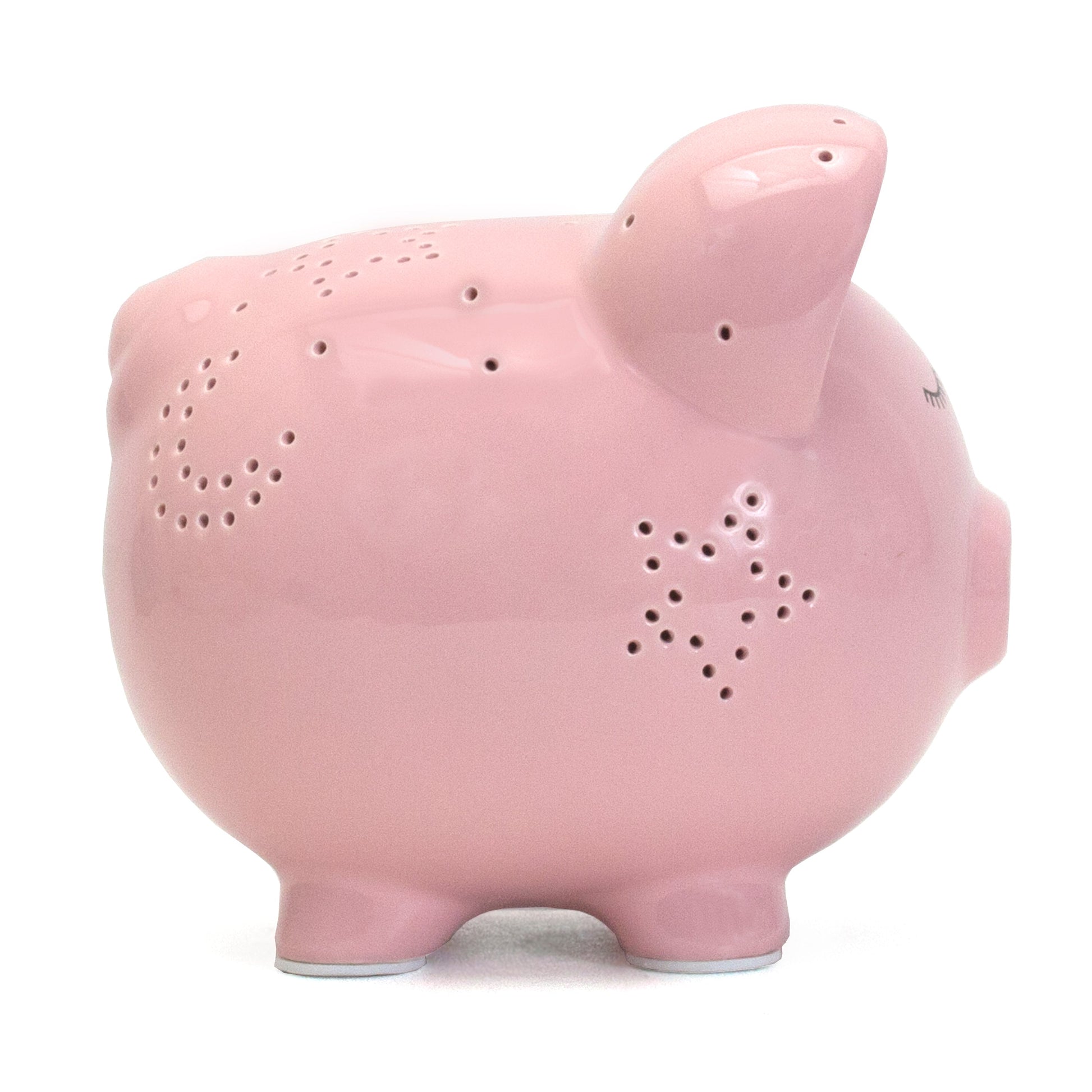 Back view of pink piggy bank with star-shaped holes for night light