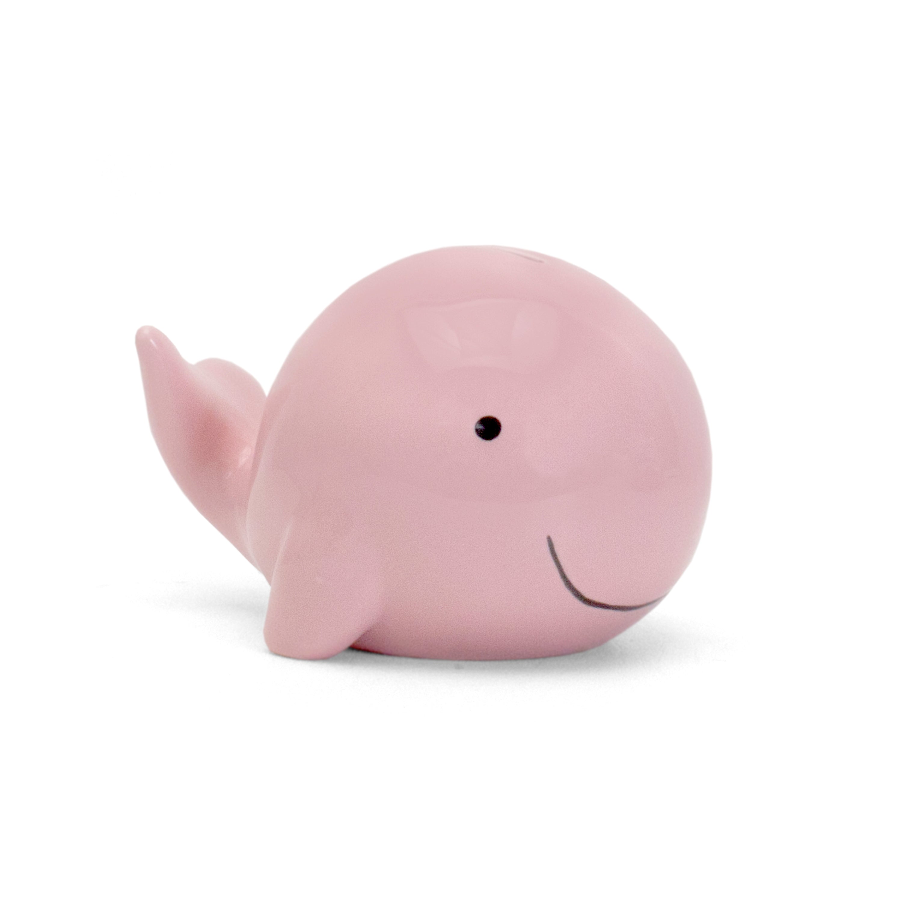 Side view of pink whale ceramic piggy bank showing glossy finish and whale tail