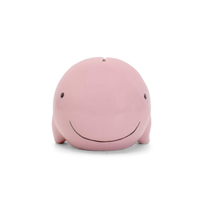 Front view of pink whale piggy bank with handpainted eyes and smiling mouth