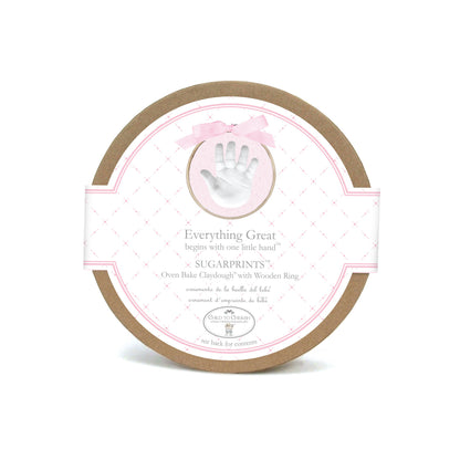 Round box packaging of Sugarprints Glitter Handprint Kit with pink border and small handprint image
