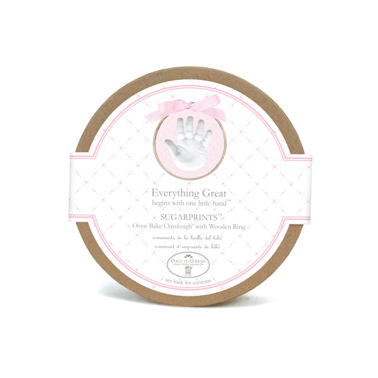 Round box packaging of Sugarprints Glitter Handprint Kit with pink border and small handprint image