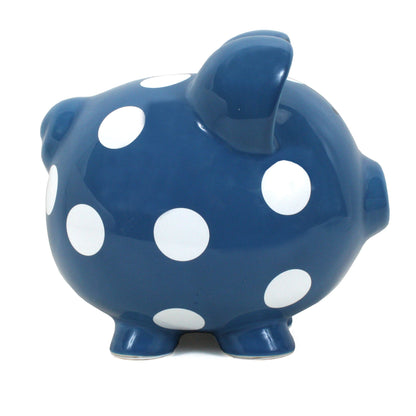 Left side view of dark blue ceramic piggy bank with round ears and white polka dots