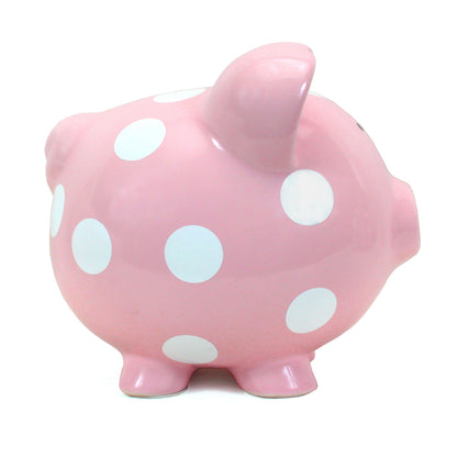 Side view of pink piggy bank showing large white polka dots on curved surface