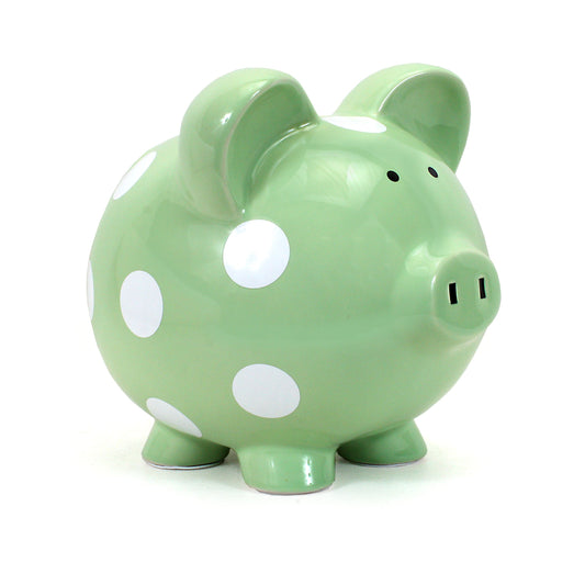 Sage green ceramic piggy bank with white polka dots angled view