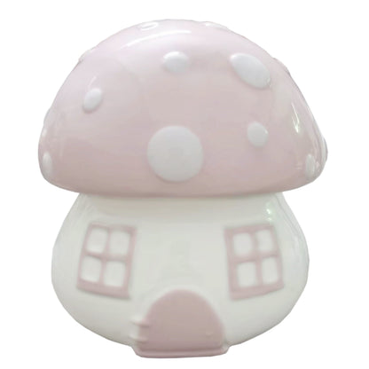 Front view of pink mushroom shaped ceramic piggy bank with white polka dots and window details