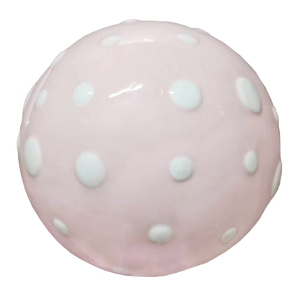 Top view showing pink mushroom cap covered with raised white polka dots on ceramic piggy bank