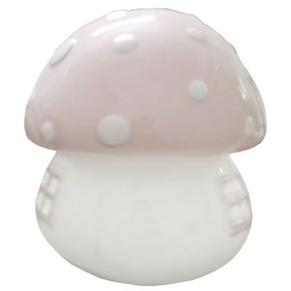Side profile of the pink and white ceramic mushroom piggy bank showing window details