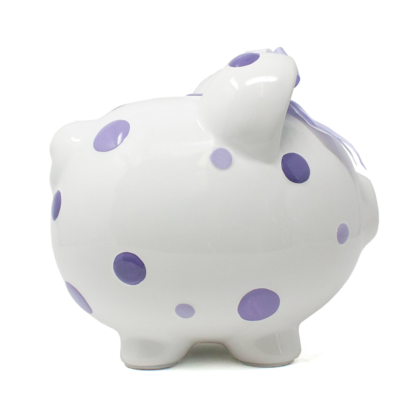 Left side view of white ceramic piggy bank featuring purple polka dots