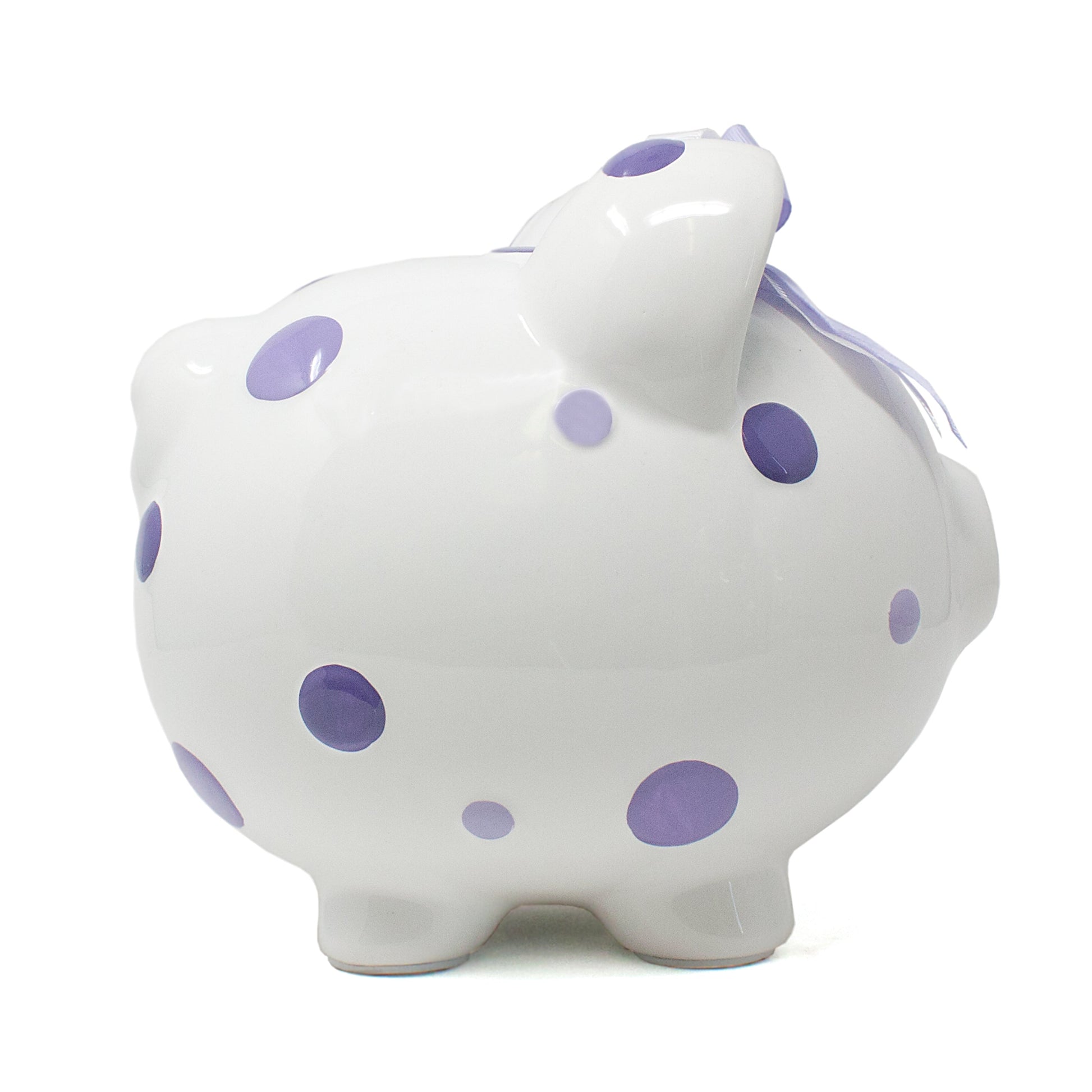 Left side view of white ceramic piggy bank featuring purple polka dots