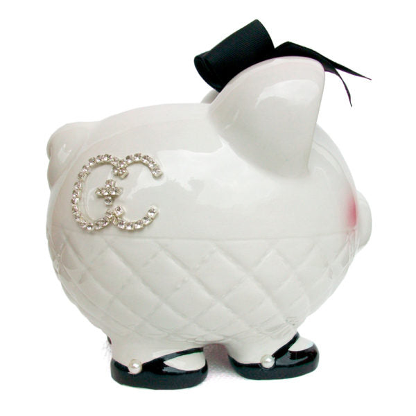 Side view of white ceramic piggy bank showing rhinestone monogram and quilted texture
