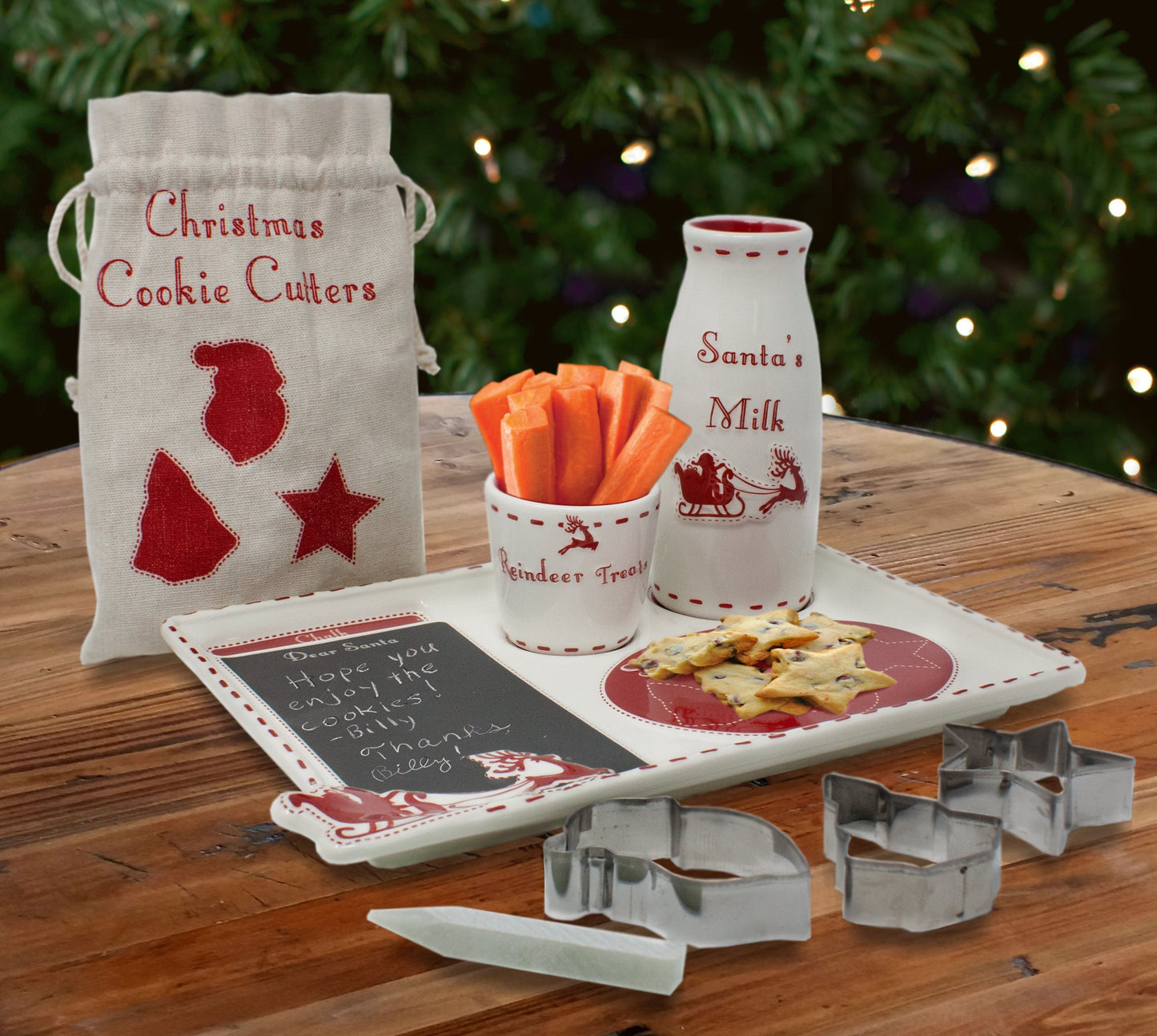 Santa's Cookie Platter set displayed with carrots in reindeer treat cup and cookie cutters beside fabric pouch on wooden table