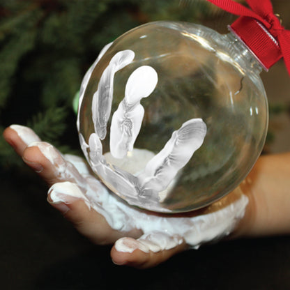 Christmas tree with Santa's Message Ornament hanging, showing handprint and message inside