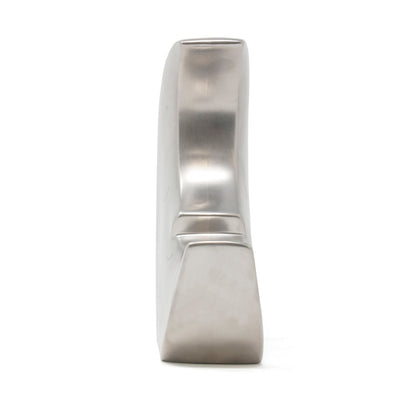 Side profile of silver metallic crescent moon piggy bank showing coin slot on top