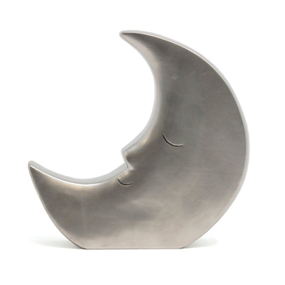 Silver crescent moon piggy bank front view showing hand sculpted eyes and nose