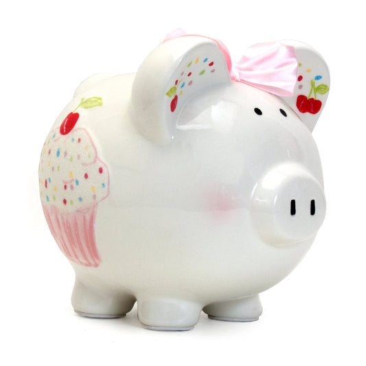 White ceramic piggy bank with handpainted sprinkles and cupcake illustration