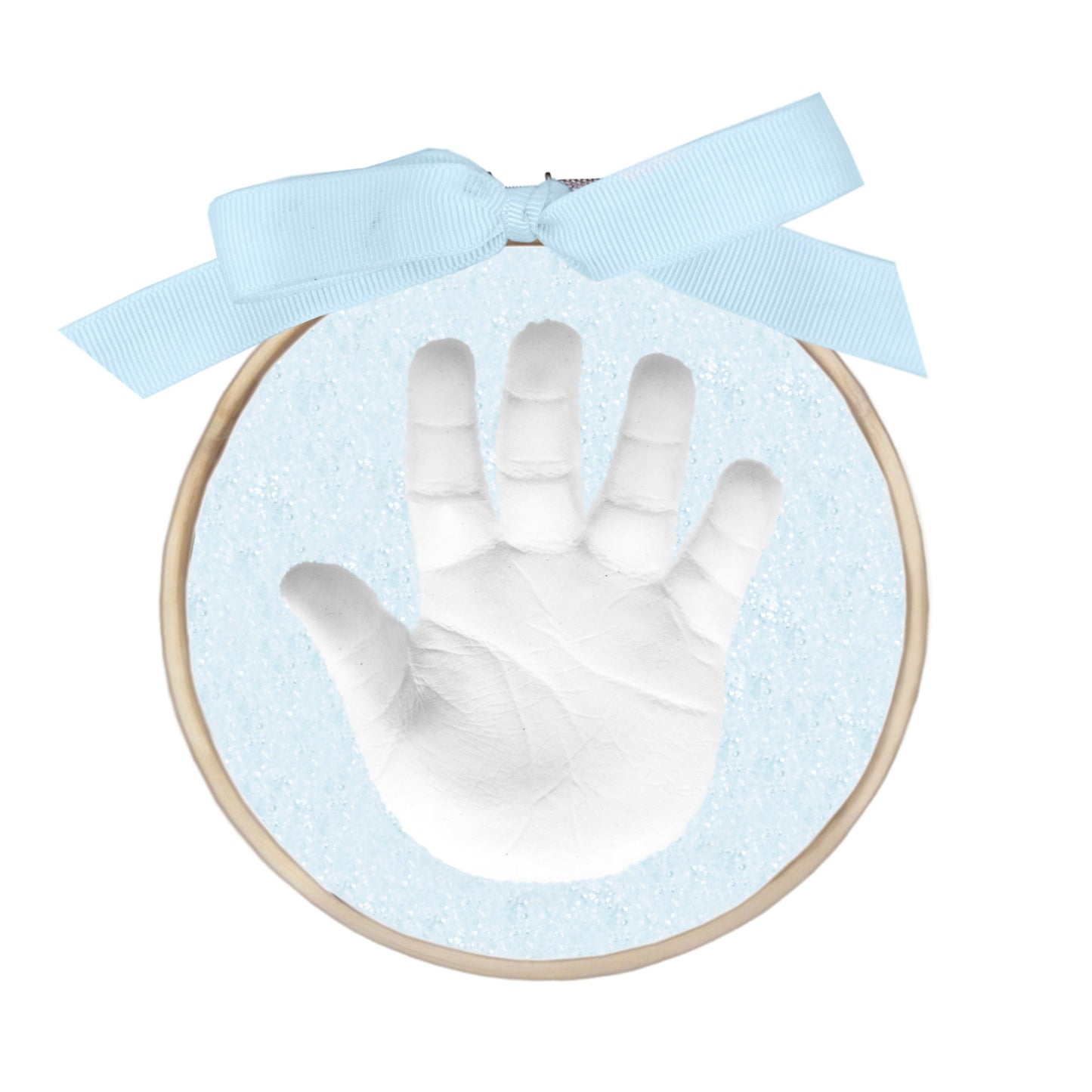 Finished handprint ornament with white handprint in blue glitter clay within a wooden ring and blue ribbon bow