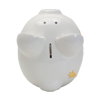 Top view of piggy bank featuring coin slot and raised ears painted with multicolor dots