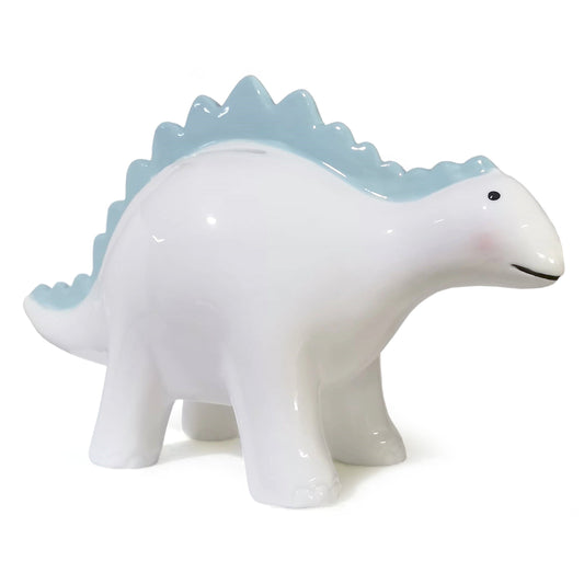 Side view of Theo the Dinosaur Blue ceramic piggy bank showing smooth white body and blue ridges along the back