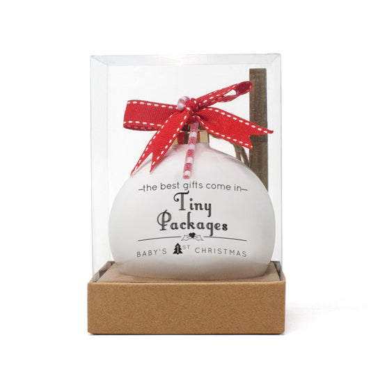 Baby's first Christmas porcelain ornament with 'Tiny Packages' text, red ribbon bow and candy cane, in clear gift box