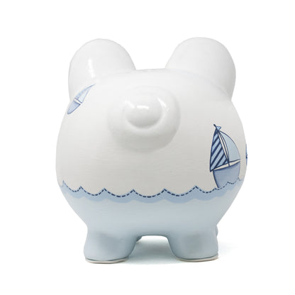 Back view of piggy bank showing the tail and partial sailboat design with handpainted details