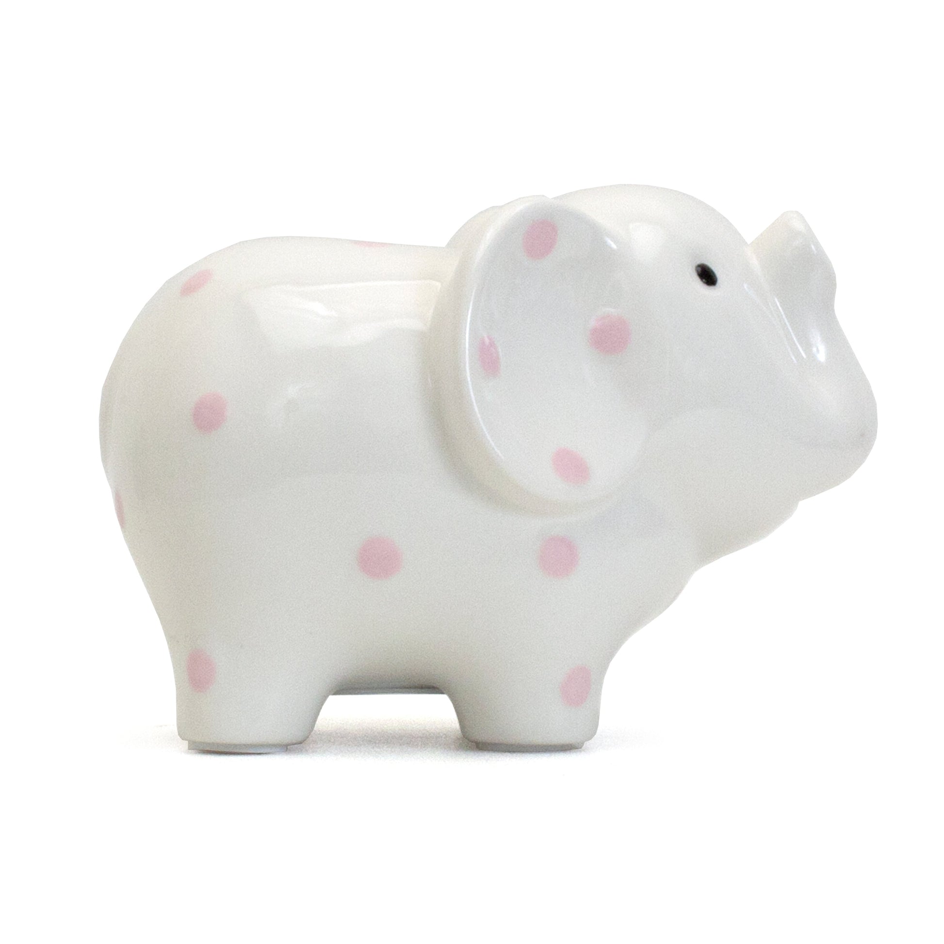 Left profile view of white ceramic elephant bank with pink polka dots