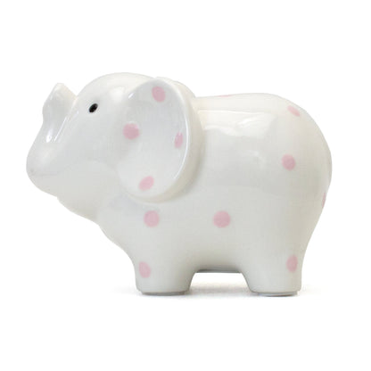 Right profile view of white ceramic elephant bank with pink polka dots