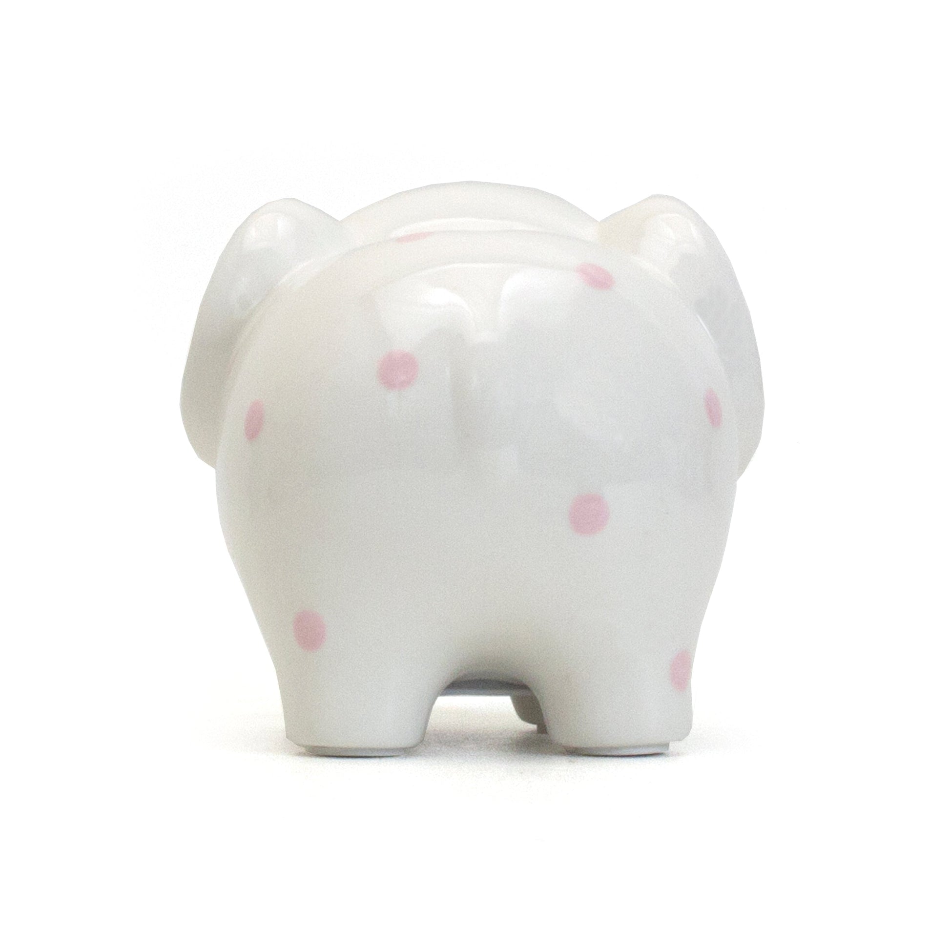 Rear view of white ceramic elephant bank showing pink polka dots