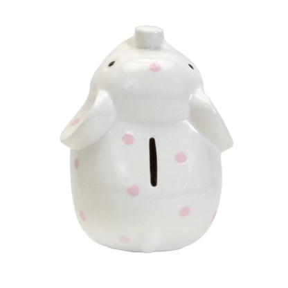 Top view showing coin slot on back of white ceramic elephant bank