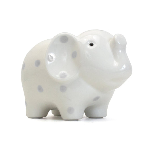 Side view of white elephant piggy bank with gray polka dots