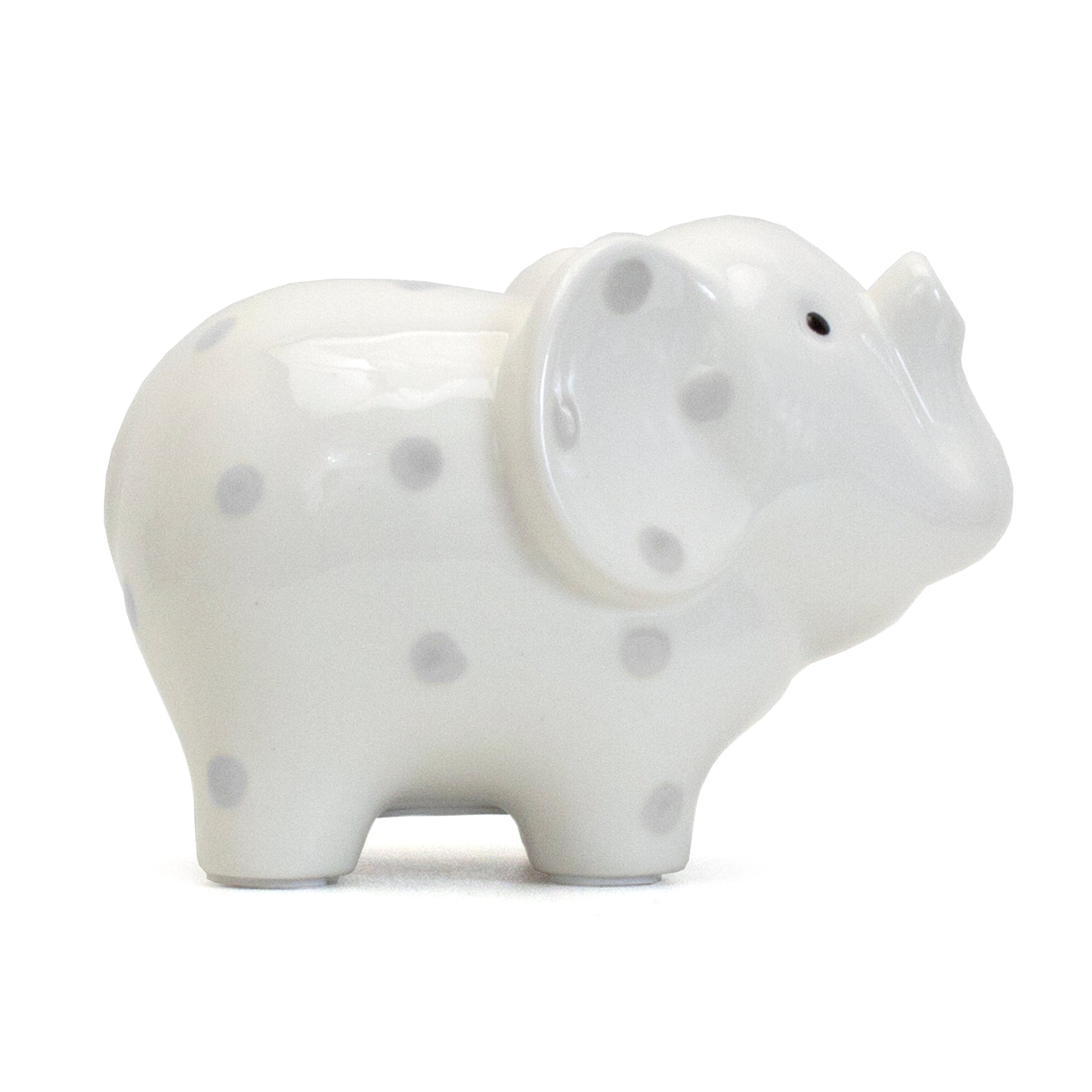 Side profile of white ceramic elephant piggy bank decorated with gray polka dots