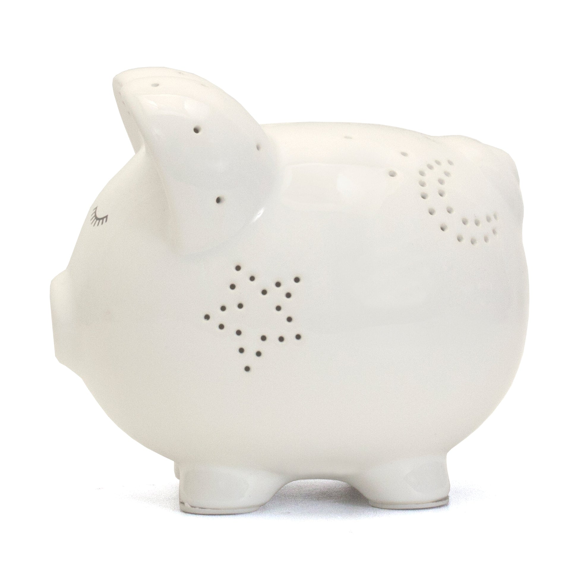 Opposite side view of white piggy bank with glowing star perforations