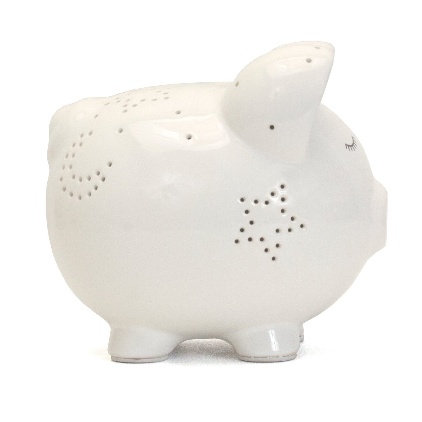 Side view showing star-shaped perforations on ceramic piggy bank ears and body