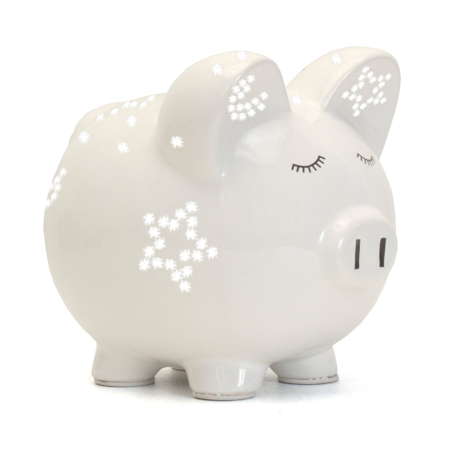 Side view of white ceramic piggy bank with star-shaped light perforations and closed eyes