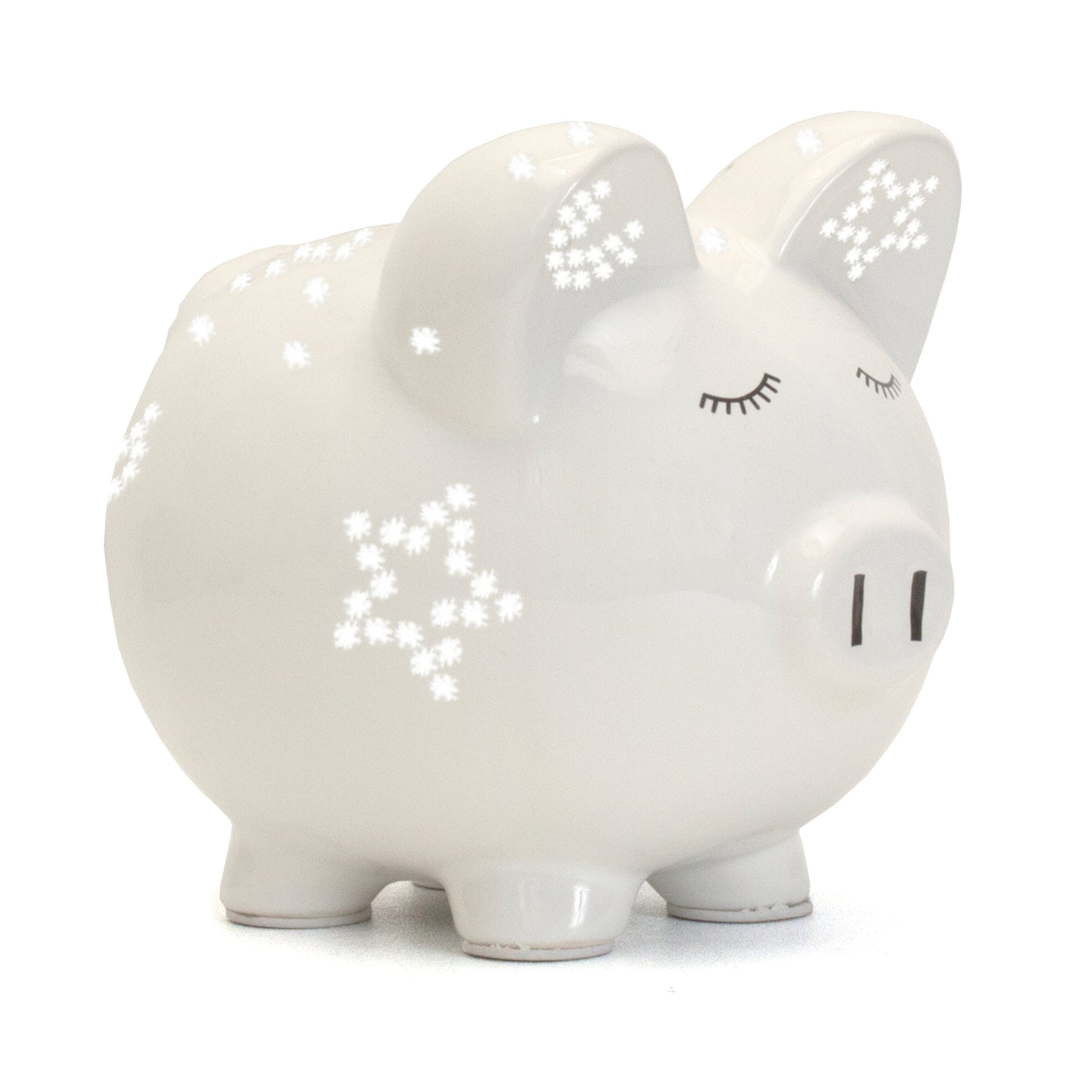 Side view of white ceramic piggy bank with star-shaped light perforations and closed eyes