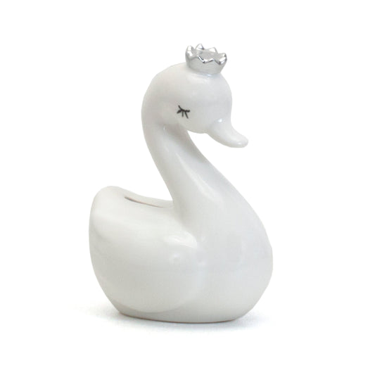 Side view of white swan ceramic piggy bank with silver crown and closed eyes