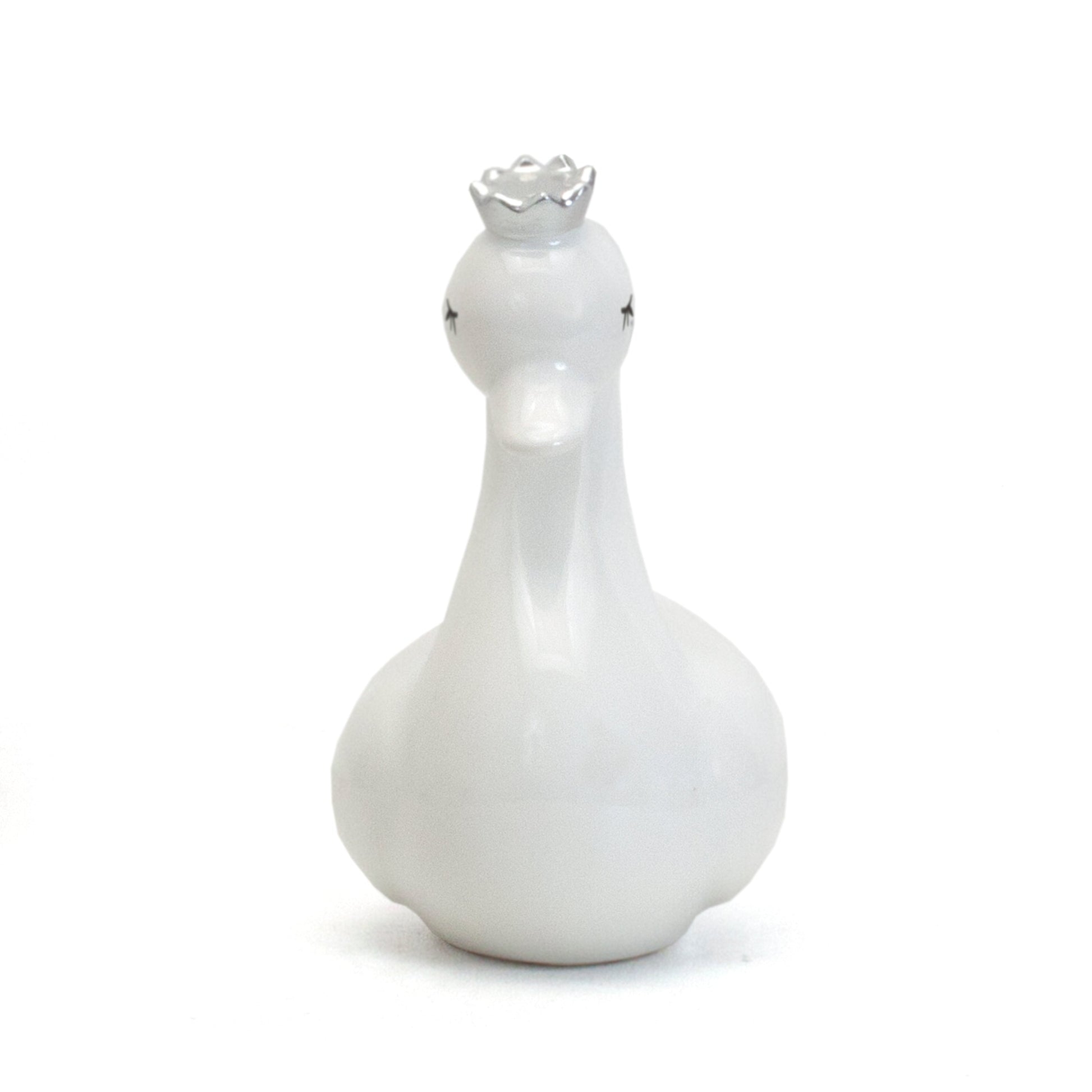Front view of white swan coin bank displaying gentle facial features and crown