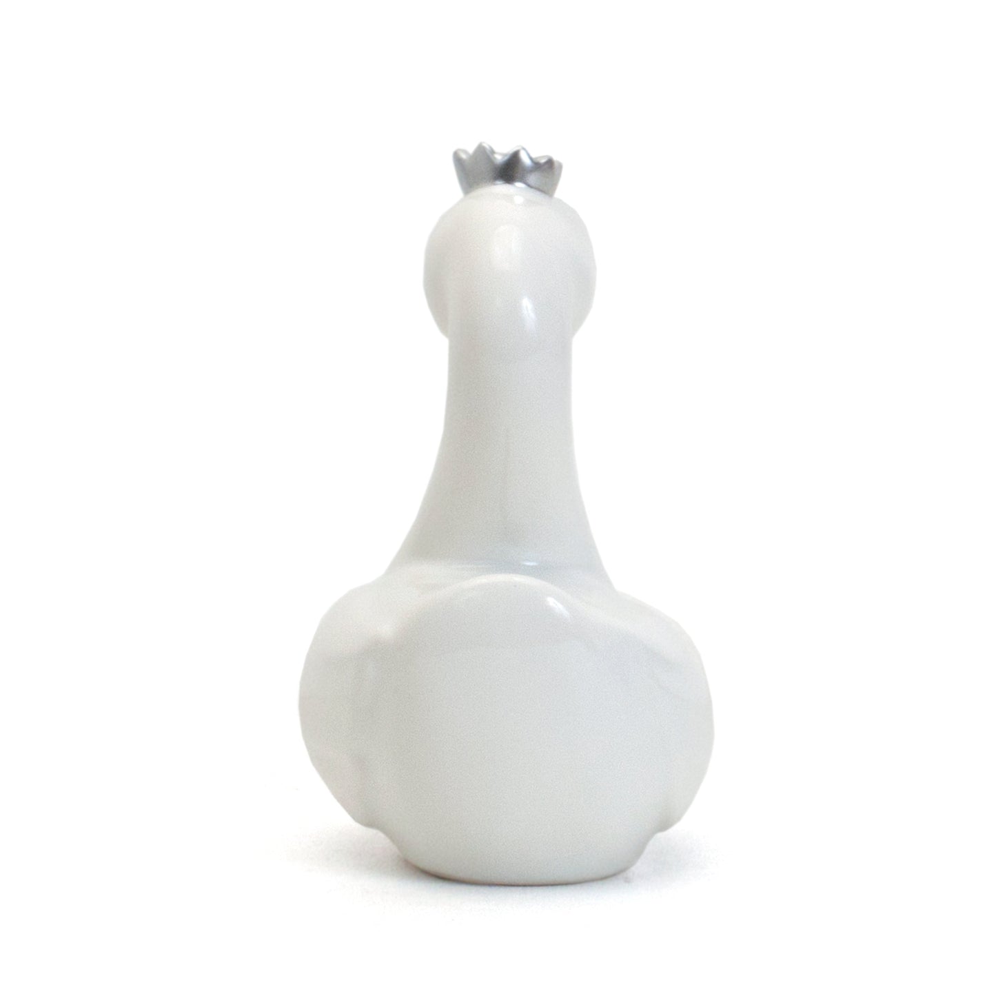 Rear view of white swan piggy bank showing smooth glossy surface and rounded shape