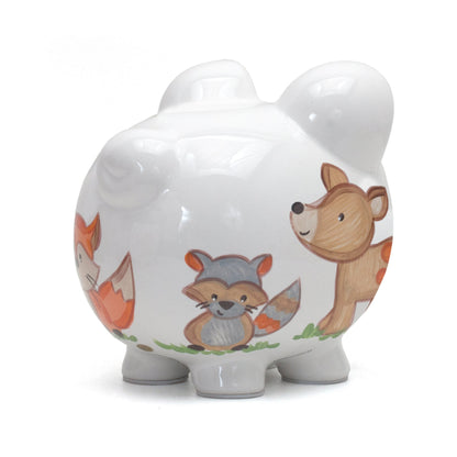 Left side view showing handpainted raccoon and deer on white piggy bank